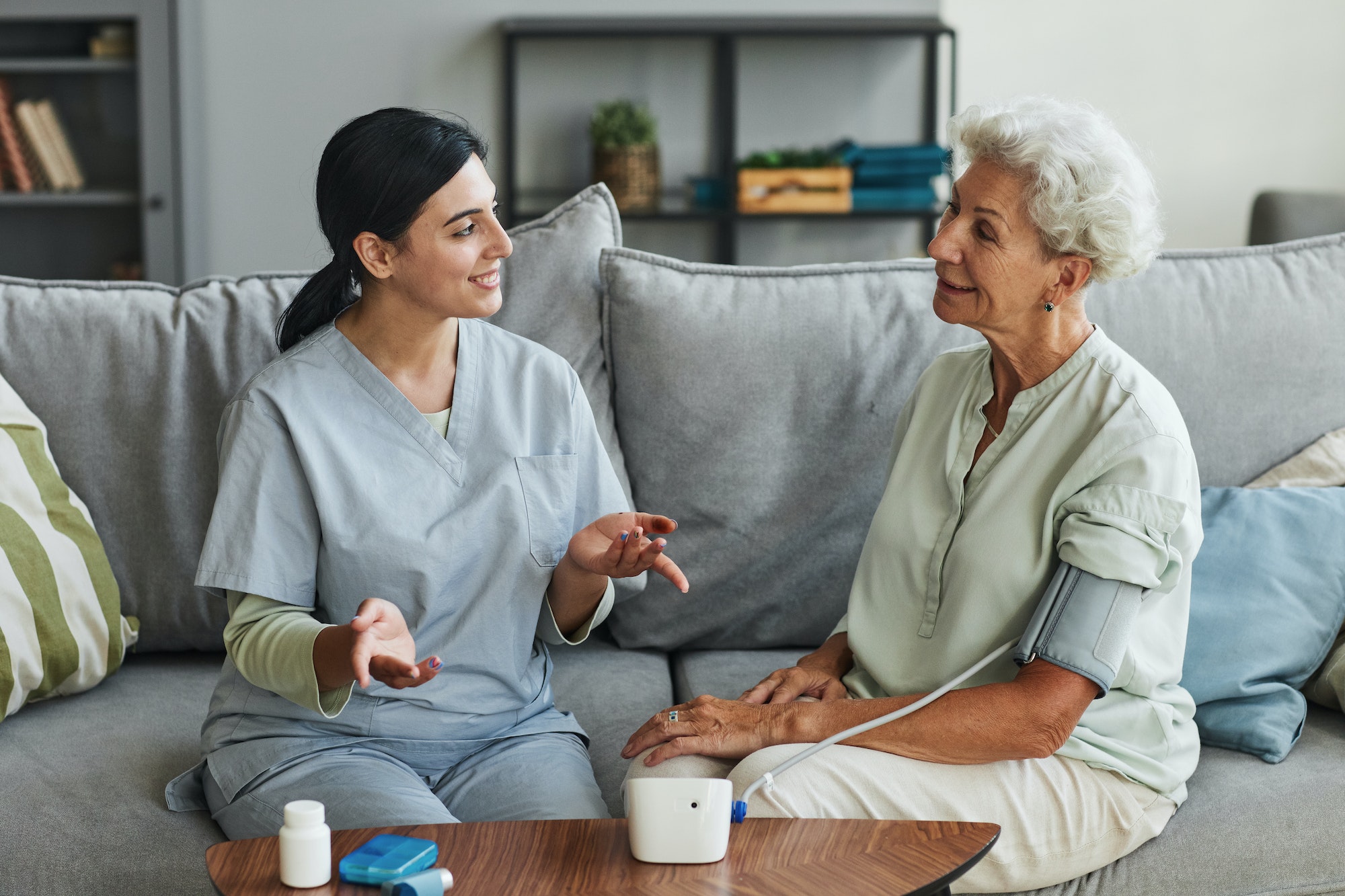 young-nurse-talking-to-senior-woman-in-retirement-home.jpg